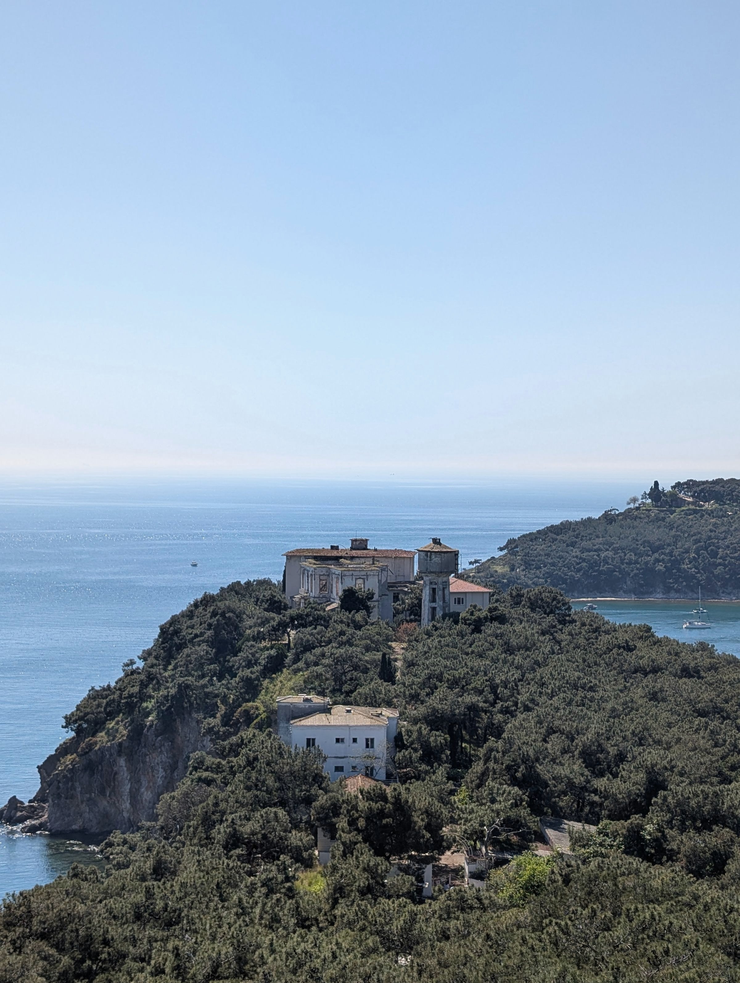 A minimalist stone villa terrace overlooking the sea